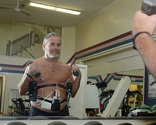 Katie Rickman | The Vindicator.Tom Lawrence of Boardman lifts weights at the YMCA of Youngstown on Thursday, Oct. 2, 2014. He is currently on a heart transplant waiting list at Cleveland Clinic and until he receives his heart he wears a L-VAD heart pump that keeps his heart going. He works out frequently, despite his heart condition, at the YMCA  in Youngstown  onThursday, Oct. 2, 2014.
