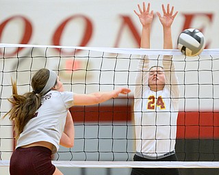 Jeff Lange | The Vindicator  Mckenzie Reese (24) jumps to block as Boardman's Hope Landers hits the ball into the net during Wednesday evening's game at Mooney.
