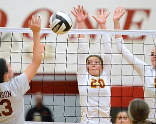 Jeff Lange | The Vindicator  Gina Patella (20) and Autumn Desantis (5) of Mooney go up to block as Boardman's Krista Johnson prepares to spike the ball during action at Mooney High School, Wednesday night.