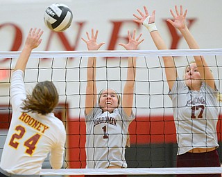 Jeff Lange | The Vindicator  Boardman's Rachel Hosa (1) and Amanda Lipke (17) go up to defend Mooney's Mckenzie Reese's spike during their matchup Wednesday evening in Youngstown.