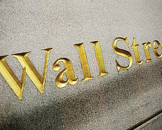 This Wednesday photo shows a Wall Street address carved into the side of a building in New York. The U.S. stock market had its worst day of the year Thursday, just 24 hours after recording its best.