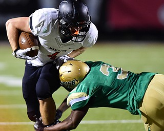 YOUNGSTOWN, OHIO - OCTOBER 10, 2014:Danny Robinson #4 of Massillon is tackled by Kimauni Johnson #3 of Ursuline during the 1st half of Friday nights OHSAA game at Stambaugh Stadium. (Photo by David Dermer/Youngstown Vindicator)