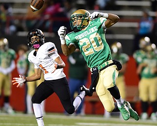 YOUNGSTOWN, OHIO - OCTOBER 10, 2014: David Collins #20 of Ursuline watches as the ball flies through the air after he tipped the ball and before it would be intercepted by Jeff Koch #1 of Massillon during the 1st half of Friday nights OHSAA game at Stambaugh Stadium. (Photo by David Dermer/Youngstown Vindicator)