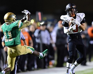 YOUNGSTOWN, OHIO - OCTOBER 10, 2014: Chase Piatko #3 catches a pass after getting behind Marcus Mosley #11 of Ursuline for a 48 yard reception during the 1st half of Friday nights OHSAA game at Stambaugh Stadium. (Photo by David Dermer/Youngstown Vindicator)