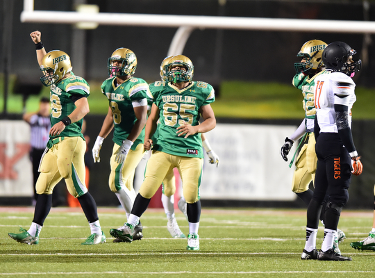 YOUNGSTOWN, OHIO - OCTOBER 10, 2014: Vito penza #39 of Ursuline of Massillon celebrates after a Massillon field goal attempt sailed wide right late in the 4th quarter during the 2nd half of Friday nights OHSAA game at Stambaugh Stadium. (Photo by David Dermer/Youngstown Vindicator) Ursuline Deion Edwards #8, Devin Matthews #65, Jabbar price #52 and Massillon Montrell Stevens #17 pictured.