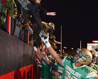 YOUNGSTOWN, OHIO - OCTOBER 10, 2014: David Collins #20 of Ursuline and several other Ursuline players celebrate with the Student section after Friday nights OHSAA game at Stambaugh Stadium. (Photo by David Dermer/Youngstown Vindicator)