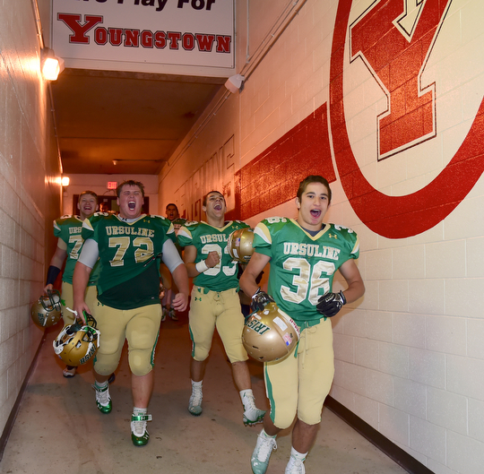 YOUNGSTOWN, OHIO - OCTOBER 10, 2014: Anthony Morgione #36, Jeff Marx #72, Nick Armeni #33 and Joe Weir #73 of Ursuline celebrate while walking to the locker room after Friday nights OHSAA game at Stambaugh Stadium. (Photo by David Dermer/Youngstown Vindicator)