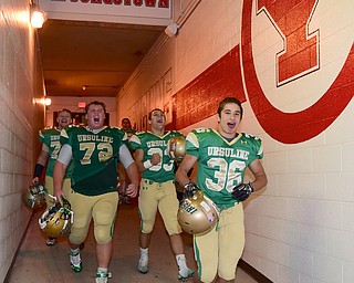 YOUNGSTOWN, OHIO - OCTOBER 10, 2014: Anthony Morgione #36, Jeff Marx #72, Nick Armeni #33 and Joe Weir #73 of Ursuline celebrate while walking to the locker room after Friday nights OHSAA game at Stambaugh Stadium. (Photo by David Dermer/Youngstown Vindicator)