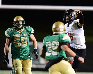YOUNGSTOWN, OHIO - OCTOBER 10, 2014: Danny Clark #6 of Massillon throws a pass while avoiding the pass rush from Vito Penza #39 and Giacamo Cappabianca #55 of Ursuline during the 1st half of Friday nights OHSAA game at Stambaugh Stadium. (Photo by David Dermer/Youngstown Vindicator)