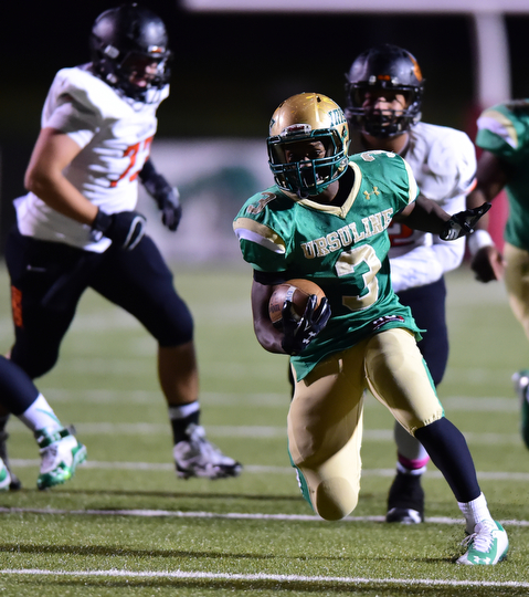 YOUNGSTOWN, OHIO - OCTOBER 10, 2014: Kimauni Johnson #3 of Ursuline runs the football in the open field after running past the Massillon defense during the 1st half of Friday nights OHSAA game at Stambaugh Stadium. (Photo by David Dermer/Youngstown Vindicator)