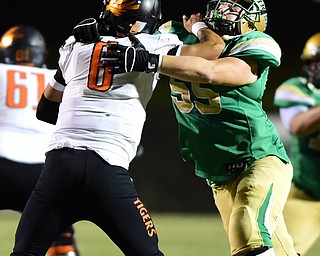 YOUNGSTOWN, OHIO - OCTOBER 10, 2014: Danny Clark #6 of Massillon attempts to avoid being brought down by Giacamo Cappabianca #55 of Ursuline during the 1st half of Friday nights OHSAA game at Stambaugh Stadium. (Photo by David Dermer/Youngstown Vindicator)