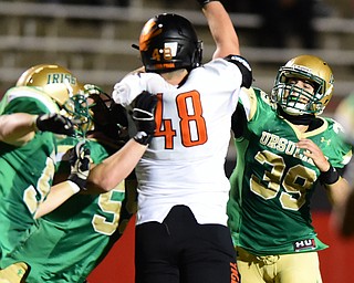 YOUNGSTOWN, OHIO - OCTOBER 10, 2014: Vito Penza #39 of Ursuline throws a pass avoiding the pass rush of Dakota Dunwiddie #48 of Massillon during the 1st half of Friday nights OHSAA game at Stambaugh Stadium. (Photo by David Dermer/Youngstown Vindicator) Giacamo Cappabianca #55 of Ursuline pictured.