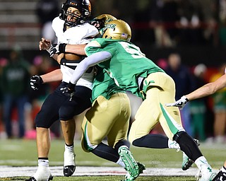 YOUNGSTOWN, OHIO - OCTOBER 10, 2014: Danny Clark #6 of Massillon is sacked in the backfield by Jabbar Price #52 and Tyler Leonard #54 of Ursuline during the 1st half of Friday nights OHSAA game at Stambaugh Stadium. (Photo by David Dermer/Youngstown Vindicator)