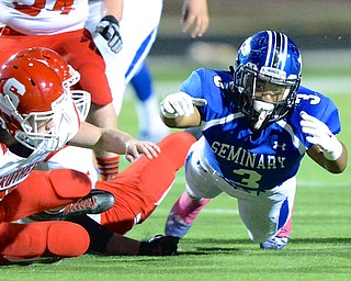Jeff Lange | The Vindicator  Poland's Marlon Ramirez (3) dives for the ball with Struthers' Robbie Best (left) after Ramirez fumbled the ball on the play in the first quarter in Poland.