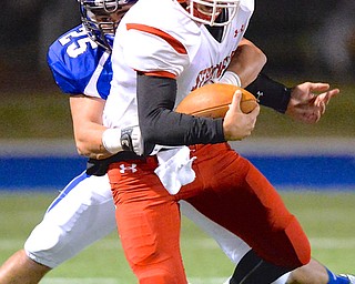 Jeff Lange | The Vindicator  Struthers' quarterback AJ Musolino is brought down from behind by Poland's Anthony Audi in the first quarter of Friday night's matchup in Poland.
