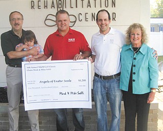 SPECIAL TO THE VINDICATOR
Mike and Mark Sahli presented $1,200 to Angels of Easter Seals from the 16th annual M&M Golf Classic Tournament, which they established to benefit local charities throughout the Mahoning Valley. The event took place at Mill Creek Park Golf Course on Aug. 31 with 144 golfers attending. Above, from left, are Tim Nelson, Easter Seals and YHS president and chief executive officer; Jackson Diaz, 2014-2015 Easter  Seals and YHS child representative; Mike and Mark Sahli, chairmen of M&M Golf Classic; and Lynn Sahli, president of Angels of Easter Seals.