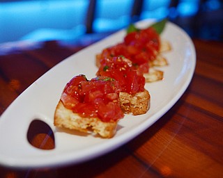 Katie Rickman | The Vindicator.Brothers in Food tasted signature dishes at the CC Restaurant in Boardman, testing dishes like duck, PEI muscles, Ahi Tuna and much more one Thursday, Oct. 9, 2014. Featured in photo is one of the small dish signatures: Bruschetta.