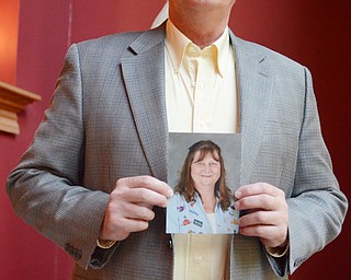 Katie Rickman | The Vindicator.D’Wayne Robinson a photo of his wife Teresa who passed away April 1, 2013 in their Canfield home  after a long battle with cancer. D'Wayne discusses his children’s book Luvya Tree which he wrote after his wife's on Thursday, Oct. 9, 2014.
