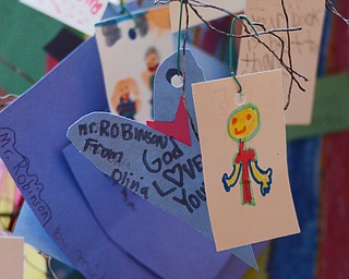 Katie Rickman | The Vindicator.Notes from children at Heartland Christian School hang from a small version of the Luvya Tree in the living room of D’Wayne Robinson’s Canfield home on Thursday, Oct. 9, 2014. D’Wayne discusses the book that he wrote called The Luvya Tree which discussed the illness of his wife and her death.