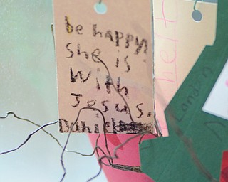 Katie Rickman | The Vindicator.Notes from children at Heartland Christian School hang from a small version of the Luvya Tree in the living room of D’Wayne Robinson’s Canfield home on Thursday, Oct. 9, 2014. D’Wayne discusses the book that he wrote called The Luvya Tree which discussed the illness of his wife and her death.