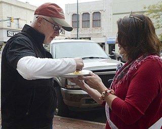Katie Rickman | The Vindicator .Dan Matthews of Youngstown takes a sample pierogi from Lisa Skomra-Lotz of North Lima during the National Pierogi Day Celebration on Thursday, Oct. 9, 2014 at Martini Brothers Burger Bar.