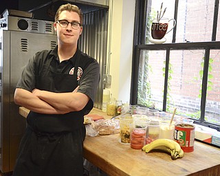 Katie Rickman | The Vindicator.Ross Fowler stands near his workspace in the kitchen of Friends Specialty where he comes up with his culinary dishes for his new restaurant The Kitchen Post on Thursday, Oct. 9, 2014.