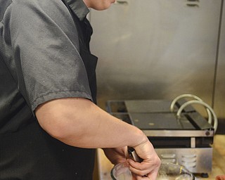 Katie Rickman | The Vindicator.Ross Fowler puts together a "Squash and Kale" salad at his new restaurant The Kitchen Post which is located in Friends Specialty downtown Youngstown on Thursday, Oct. 9 2014.