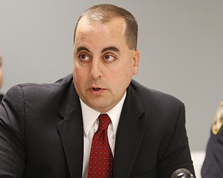        ROBERT K. YOSAY  | THE VINDICATOR..Marty Desmond Asst prosecutor - - Jeff  Solic  to his left  and Brian Goodin Chief Poland Twp  ( in uniform)..talk about the rash of burgularies recently and stopping them..-30-