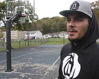 William D. Lewis The Vindicator  Dom DeFrank, 19, of Lowellville, stands on basketball court. He won an online contest to help fund restoration of the courts.