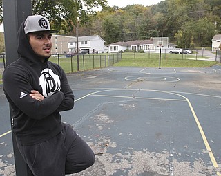 William D. Lewis The Vindicator  Dom DeFrank, 19, of Lowellville, stands on basketball court. He won an online contest to help fund restoration of the courts.