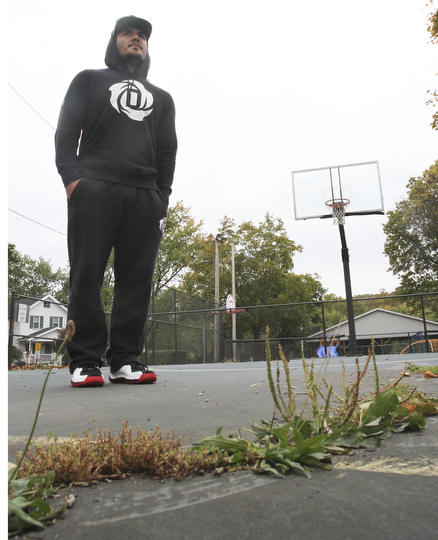 William D. Lewis The Vindicator  Dom DeFrank, 19, of Lowellville, stands on basketball court. He won an online contest to help fund restoration of the courts.