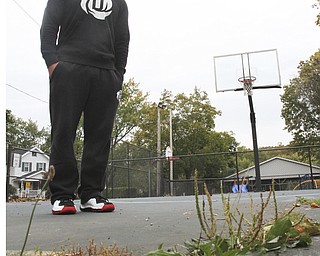 William D. Lewis The Vindicator  Dom DeFrank, 19, of Lowellville, stands on basketball court. He won an online contest to help fund restoration of the courts.
