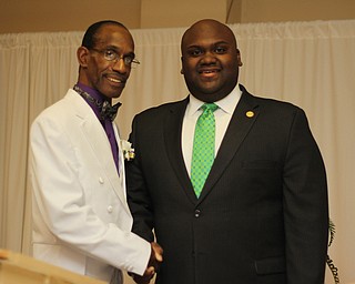 Steven Mickel (left) of the NAACP Youngstown chapter shakes hands with Sammie Dow , National Youth and College Director of the NAACP, during the NAACP banquit at the Mahoning Country Club in Liberty on Friday evening.  Dustin Livesay  |  The Vindicator  10/10/14  Mahoning Country Club