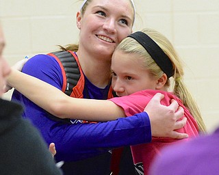 Jeff Lange | The Vindicator  Aleah Hughes (left) of Western Reserve is greeted with a hug from her 11 year old cousin Jessica Hughes after her victory over Sebring, Thursday night at Reserve. Aleah reached the milestone of 1,100 kills in the first game of last night's matchup.