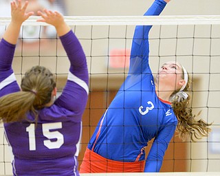 Jeff Lange | The Vindicator  Reserve senior Aleah Hughes (3) reaches out to spike the ball as Sebring's Megan McIlvain attempts to block it. Hughes celebrated her 1,100th kill during Thursday night's game against Sebring.