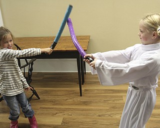 William D Lewis the Vinidcator  Lila Gordon, 6, left of Poland and Alex Taylor, 6, of Struthers dressed in a Princecess Leia costume during a star wars thmed event Saturday 10-1-14 at the Poland Library.
