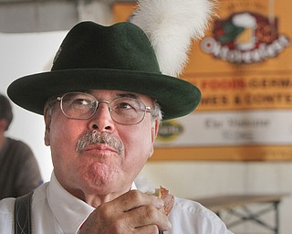 William D Lewis the vindicator Tom Englert, member of Alpen Schuhplatter Dancers of Pittsburgh enjoys a German pretzel during Oktoberfest Youngstown at Kravitz Deli in Liberty Sunday.