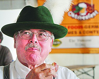 William D Lewis the vindicator Tom Englert, member of Alpen Schuhplatter Dancers of Pittsburgh enjoys a German pretzel during Oktoberfest Youngstown at Kravitz Deli in Liberty Sunday.