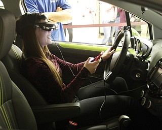        ROBERT K. YOSAY  | THE VINDICATOR..laughing as she crashes...   nya beconder. (ok) .. is behind the chevy State Farm brought in a car courtesy of Sweeney Chevrolet -  to Boardman  high school so that students can do demos of different driving scenarios. Supposed to teach driving safety, such as not to text and drive. etc.....-30-