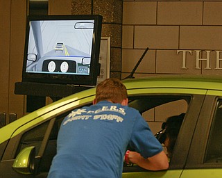        ROBERT K. YOSAY  | THE VINDICATOR..Watching the monitor and giving instructions as the monitor shows her going left of center and crashing while they texted.. State Farm brought in a car courtesy of Sweeney Chevrolet -  to Boardman  high school so that students can do demos of different driving scenarios. Supposed to teach driving safety, such as not to text and drive. etc.....-30-