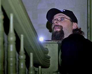 Jeff Lange | The Vindicator  Newton Falls resident Thomas Hull shines his flashlight up a staircase on the second floor  of the J.C. Thompson Building in East Liverpool, Saturday, Oct. 11th.