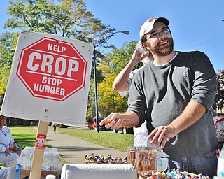 Jeff Lange | The Vindicator  Martin Luther Lutheran Church  Pastor David Kamphuis of Youngstown makes a pitstop at a food table during the CROP Walk held in Youngstown, Sunday afternoon.
