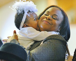 Jeff Lange | The Vindicator  Eres McKee, embraces her 1 year old daughter Karis during Sunday's services at Tabernacle Baptist Church in Youngstown.