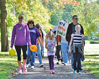 Jeff Lange | The Vindicator  Casey Brookbank (center) walks with her family Mandie (mom, front left), Jaelyn (sister, front right) Tim (dad, back right) and others through the park during Sunday's CROP Walk in Youngstown.