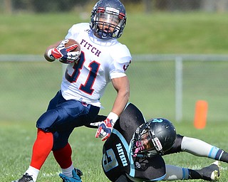 Jeff Lange | The Vindicator  Tyler Hewlett (31) of Fitch breaks away from East's Jonathon Gregory during first half action at Rayen Stadium, Saturday afternoon.