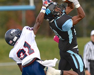 Jeff Lange | The Vindicator  Fitch's Dwayne Howell (left) yanks East's Isaiah Nuckles down as he catches a pass in the first half of Saturday's game in Youngstown.