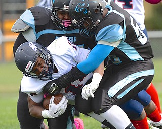 Jeff Lange | The Vindicator  Fitch's Antwan Harris (center) is taken down by a couple of Panthers defenders during first half action at Rayen Stadium, Saturday afternoon.