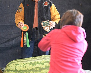 Jeff Lange | The Vindicator  Bill Neptune poses with his award winning watermelon that weighed in at 272.5 pounds, Saturday morning during the 20th annual Giant Pumpkin Weigh-Off at Parks Garden Center.