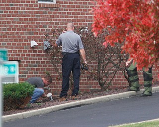        ROBERT K. YOSAY  | THE VINDICATOR..Youngstown Police Dept Bomb Squad and Mahoning County Sheriffs Dept .. investigate the area where the supposed pipe bomb was detonated...The Youngstown Police Dept  bomb squad set off what appeared to be a pipe bomb outside a broken window at the Betras, Harshman and Kopp law office in Canfield on Seville Dr...that ended up not being explosive....-30-