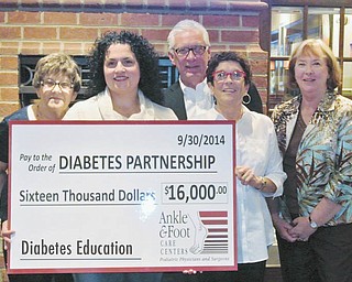 SPECIAL TO THE VINDICATOR Ankle & Foot Care Centers recently presented a $16,000 donation to the Diabetes Partnership of the Mahoning Valley to support the group’s diabetes education and research programs. From left to right are Jean Rider, Dr. Michelle Anania, Ed Hassay, Marg Hassay and Lyn Hemminger. Also attending the presentation was board member Marsha Kamensky. Dr. Anania, with Ankle & Foot Care Centers, presented the check. The others are diabetes partnership board members.